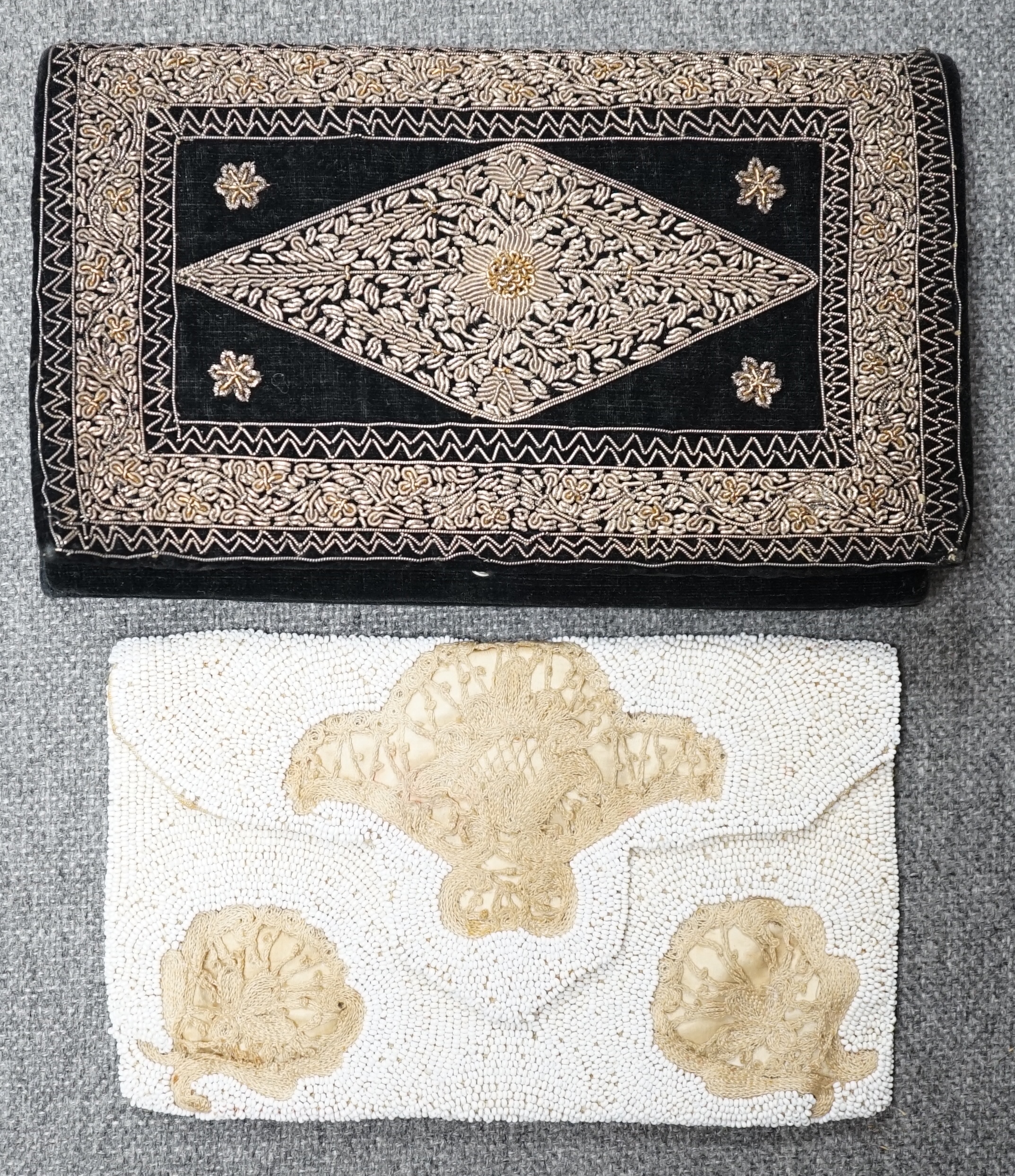 A 1940’s black velvet gold and silver embroidered evening clutch bag and an earlier 1930’s bead worked evening bag and an another black velvet bag,1940’s clutch bag 21cm wide. Condition - black bag good, white bead bag i